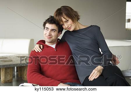 Couple embracing in a living-room View Large Photo Image Stock Image - Couple embracing in a living-room. Fotosearch