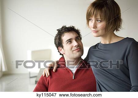 Couple embracing in a living-room View Large Photo Image Stock Photo - Couple embracing in a living-room. Fotosearch