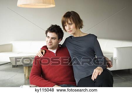 Couple embracing in a living-room View Large Photo Image Stock Photo - Couple embracing in a living-room. Fotosearch