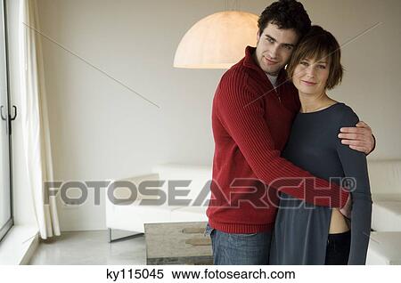 Couple embracing in a living-room View Large Photo Image Stock Photography - Couple embracing in a living-room. Fotosearch