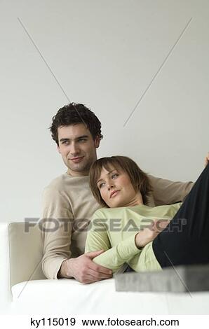 Couple lying on a sofa View Large Photo Image Stock Photo - Couple lying on a sofa. Fotosearch