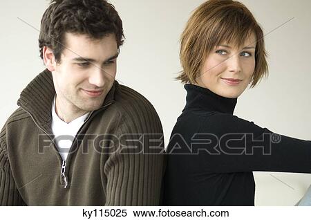 Couple sitting back to back View Large Photo Image Stock Photography - Couple sitting back to back. Fotosearch