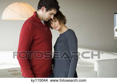 Couple standing face to face in a living-room View Large Photo Image Picture - Couple standing face to face in a living-room. Fotosearch