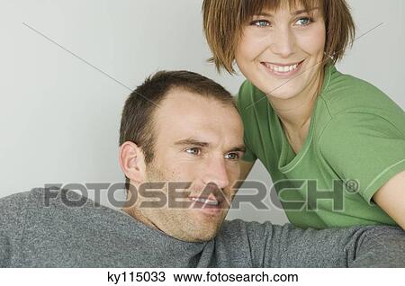 Stock Image - Portrait of a young smiling couple. Fotosearch