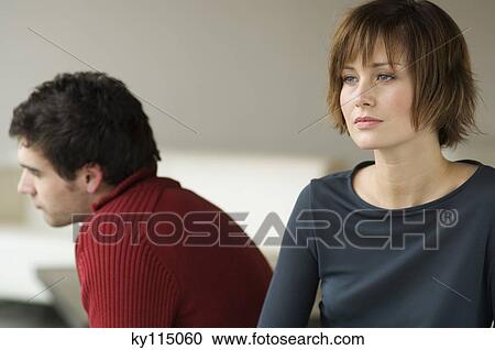Sad looking couple in a living-room View Large Photo Image Stock Image - Sad looking couple in a living-room. Fotosearch