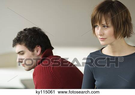 Sad looking couple in a living-room View Large Photo Image Stock Image - Sad looking couple in a living-room. Fotosearch