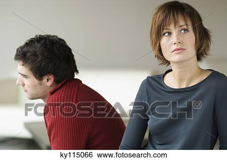 Sad looking couple in a living-room View Large Photo Image Stock Photograph - Sad looking couple in a living-room. Fotosearch