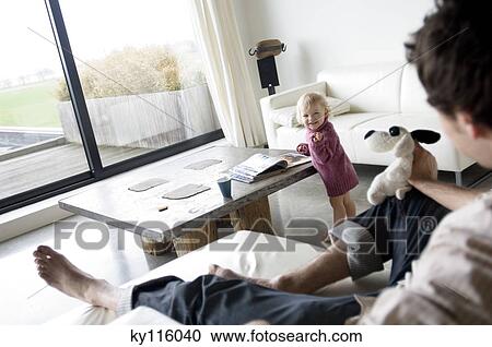 Man and little boy in a living-room View Large Photo Image Stock Image - Man and little boy in a living-room. Fotosearch