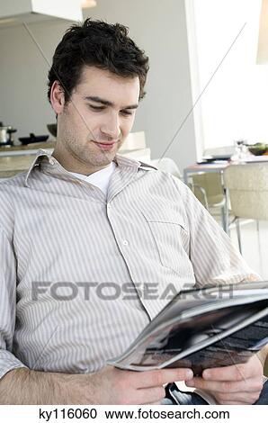 Man reading a magazine View Large Photo Image Stock Image - Man reading a magazine. Fotosearch