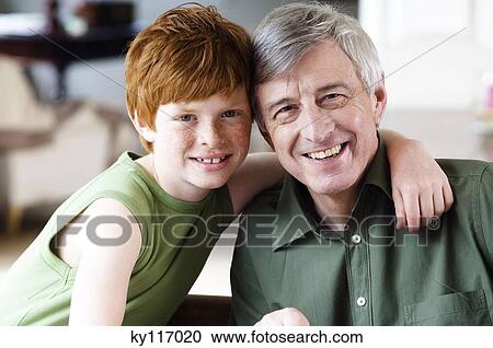 Boy embracing smiling senior man, looking at the camera View Large Photo Image Stock Image - Boy embracing smiling senior man, looking at the camera. Fotosearch