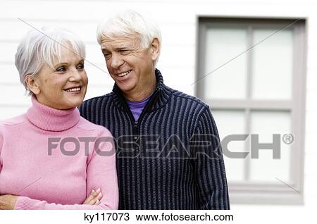 Portrait of a senior couple embracing, looking at each other, outdoors View Large Photo Image Stock Image - Portrait of a senior couple embracing, looking at each other, outdoors. Fotosearch