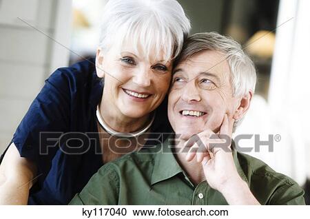 Portrait of a smiling senior couple, indoors View Large Photo Image Stock Image - Portrait of a smiling senior couple, indoors. Fotosearch