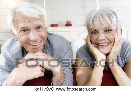Senior couple lying on bed, smiling for the camera View Large Photo Image Stock Image - Senior couple lying on bed, smiling for the camera. Fotosearch