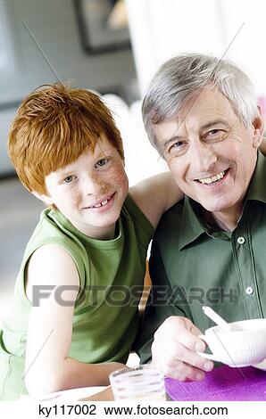 Stock Image - Senior man and boy smiling for the camera. Fotosearch