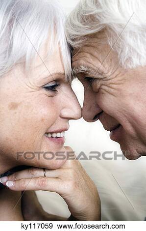 Smiling senior couple face to face, close-up View Large Photo Image Stock Photo - Smiling senior couple face to face, close-up. Fotosearch