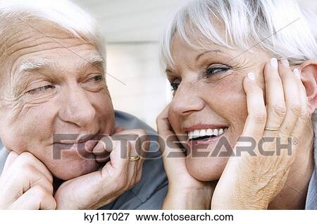 Smiling senior couple looking at each other, close-up View Large Photo Image Stock Photo - Smiling senior couple looking at each other, close-up. Fotosearch