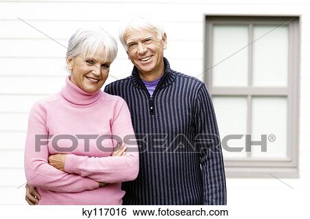 Smiling senior couple looking at the camera, outdoors View Large Photo Image Stock Photograph - Smiling senior couple looking at the camera, outdoors. Fotosearch