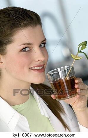 Portrait of a woman drinking tea View Large Photo Image Stock Photo - Portrait of a woman drinking tea. Fotosearch
