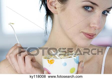 Portrait of a woman eating bean sprouts View Large Photo Image Stock Photo - Portrait of a woman eating bean sprouts. Fotosearch