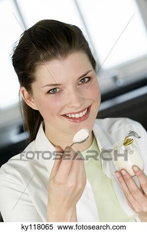Portrait of a young smiling woman eating a plain yogurt View Large Photo Image Stock Photography - Portrait of a young smiling woman eating a plain yogurt. Fotosearch