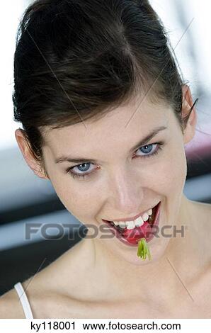 Portrait of a young woman biting into a radish View Large Photo Image Stock Image - Portrait of a young woman biting into a radish. Fotosearch