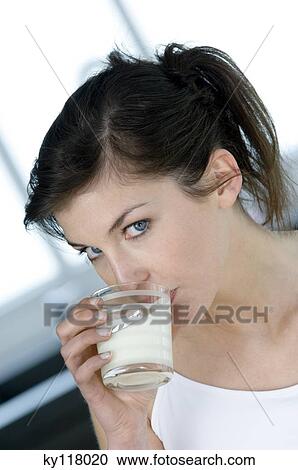 Stock Image - Portrait of a young woman drinking milk. Fotosearch