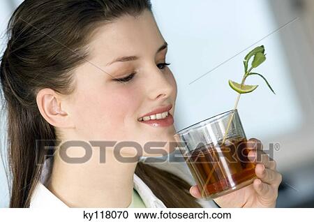 Portrait of a young woman drinking tea View Large Photo Image Stock Image - Portrait of a young woman drinking tea. Fotosearch