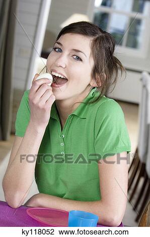 Young woman eating an hard-boiled egg View Large Photo Image Stock Image - Young woman eating an hard-boiled egg. Fotosearch