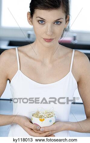 Young woman holding a bowl of bean sprouts View Large Photo Image Stock Image - Young woman holding a bowl of bean sprouts. Fotosearch