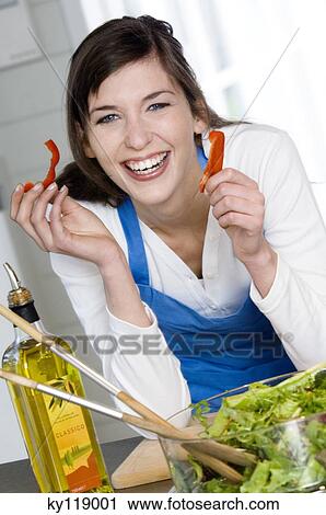 Portrait of a smiling woman making a salad View Large Photo Image Stock Image - Portrait of a smiling woman making a salad. Fotosearch
