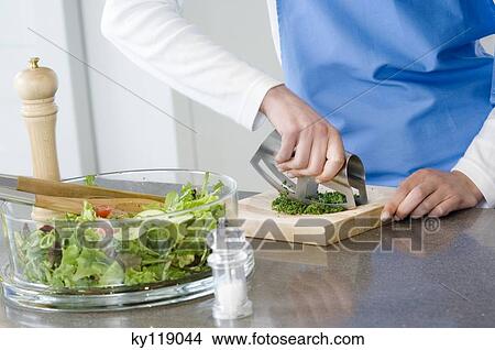 Woman chopping parsley, close-up View Large Photo Image Picture - Woman chopping parsley, close-up. Fotosearch