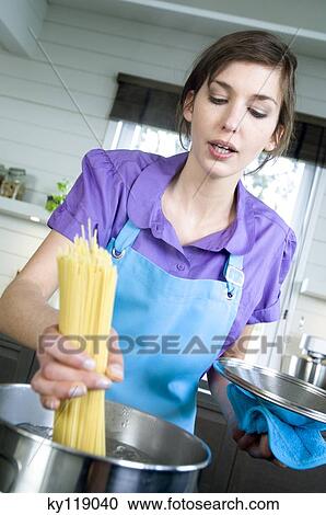 Woman cooking pasta View Large Photo Image Stock Image - Woman cooking pasta. Fotosearch