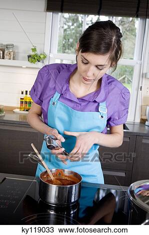 Woman cooking, using a garlic squeezer View Large Photo Image Stock Image - Woman cooking, using a garlic squeezer. Fotosearch