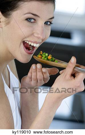 Young smiling woman tasting cooked vegetables View Large Photo Image Stock Image - Young smiling woman tasting cooked vegetables. Fotosearch