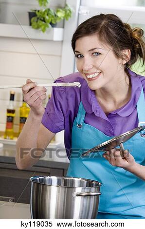 Young smiling woman tasting food View Large Photo Image Stock Photography - Young smiling woman tasting food. Fotosearch