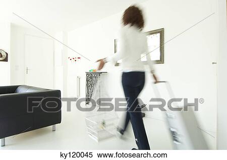 Woman carrying suitcase and birdcage in a living-room View Large Photo Image Stock Photography - Woman carrying suitcase and birdcage in a living-room. Fotosearch