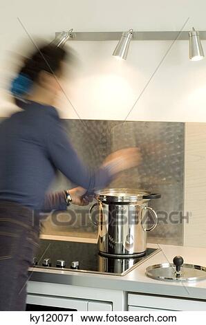 Woman cooking in a steam cooker View Large Photo Image Stock Image - Woman cooking in a steam cooker. Fotosearch