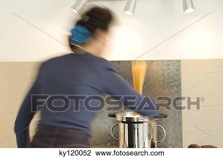 Woman cooking pasta View Large Photo Image Stock Image - Woman cooking pasta. Fotosearch