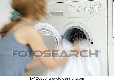 Woman emptying washing machine, close-up View Large Photo Image Stock Photograph - Woman emptying washing machine, close-up. Fotosearch