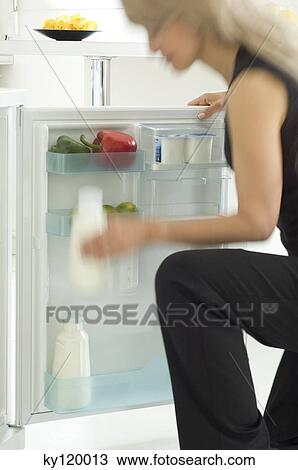 Woman looking in refrigerator View Large Photo Image Stock Image - Woman looking in refrigerator. Fotosearch