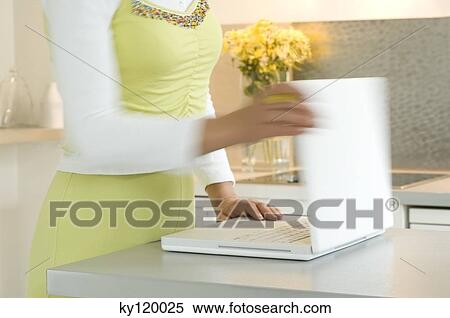 Woman opening laptop, close-up View Large Photo Image Stock Photography - Woman opening laptop, close-up. Fotosearch