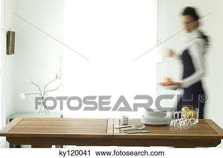 Woman setting the table View Large Photo Image Stock Image - Woman setting the table. Fotosearch