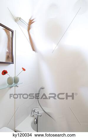Woman taking a shower, view through shower curtain View Large Photo Image Picture - Woman taking a shower, view through shower curtain. Fotosearch