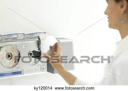 Woman using a CD player View Large Photo Image Picture - Woman using a CD player. Fotosearch