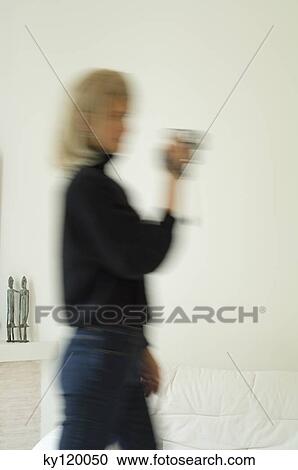 Woman using a video camera View Large Photo Image Stock Image - Woman using a video camera. Fotosearch