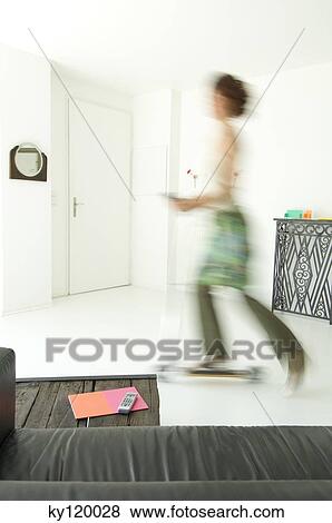 Woman using scooter in a living-room View Large Photo Image Stock Photo - Woman using scooter in a living-room. Fotosearch