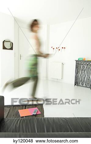 Woman using scooter in a living-room View Large Photo Image Stock Photo - Woman using scooter in a living-room. Fotosearch