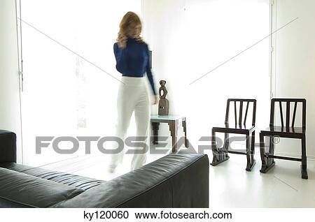 Woman walking in a living-room View Large Photo Image Stock Image - Woman walking in a living-room. Fotosearch