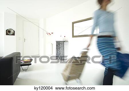 Woman with shopping trolley in a living-room View Large Photo Image Picture - Woman with shopping trolley in a living-room. Fotosearch