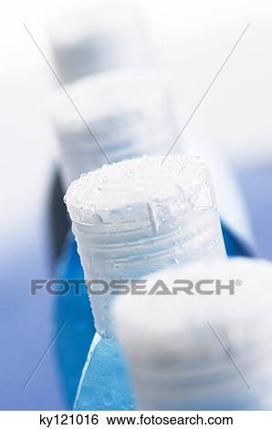 Stock Photograph - Bottles tops with waterdrops. Fotosearch